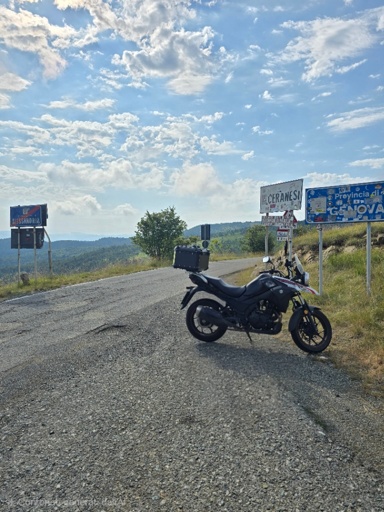 A picture of a motorbike in front of some road signs.